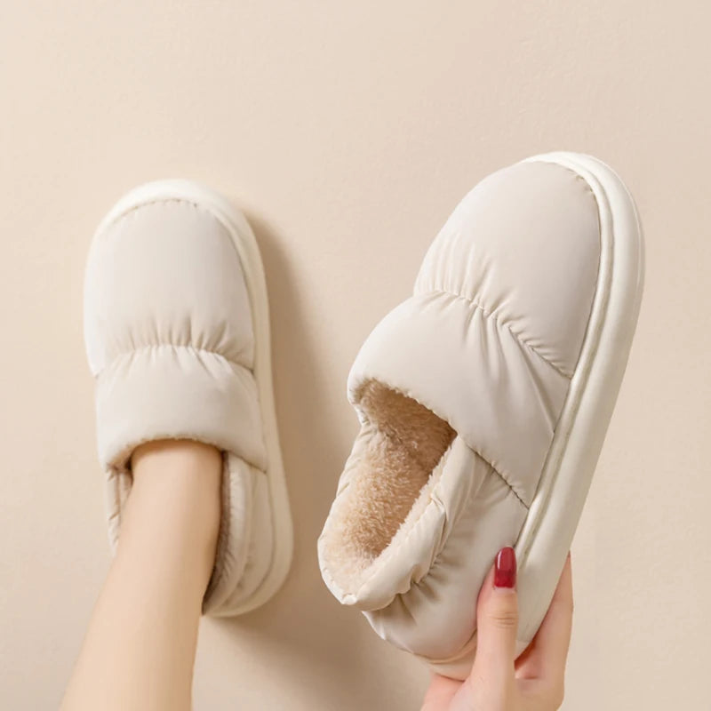 Cream Cloowdy slipper held in hand